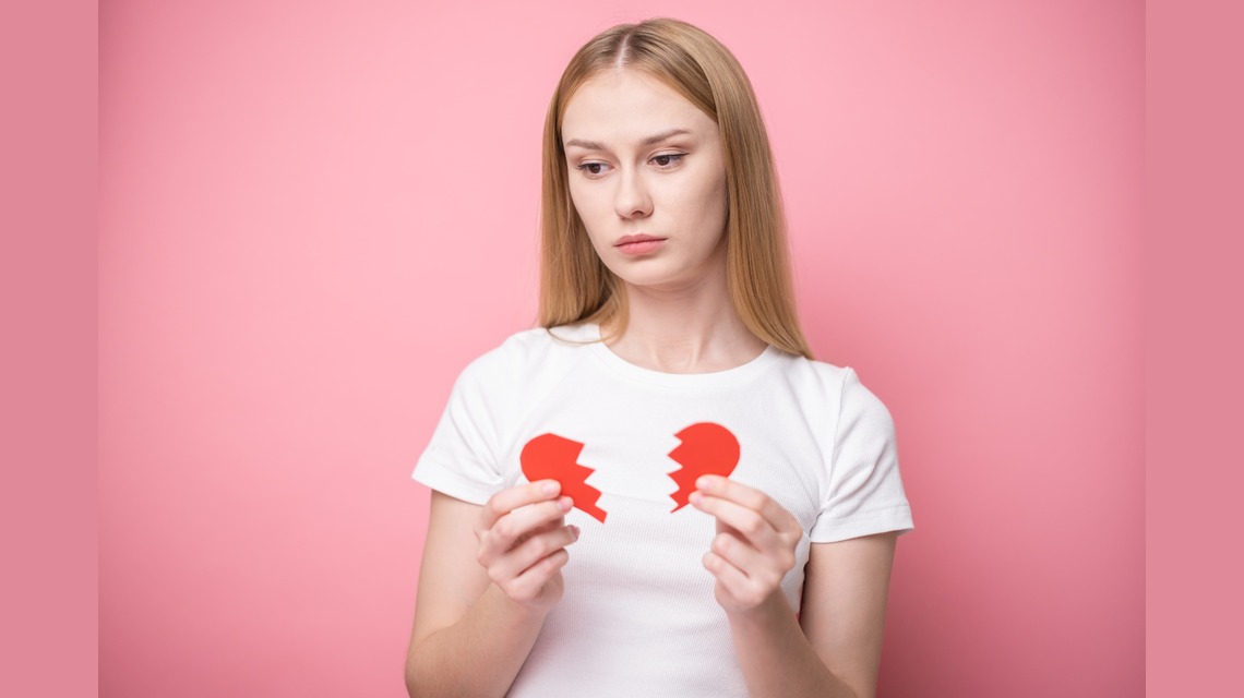 Jeune femme tenant un cœur brisé, illustration d'un article LMDE sur la reconstruction après une relation toxique